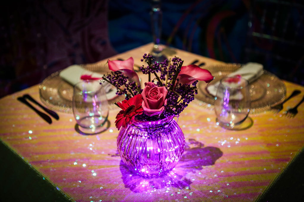 Neon inspired wedding table setting, with neon pink light up flower vase