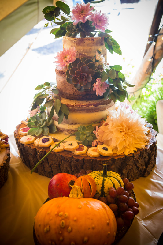 Rustic semi naked wedding cake with fresh flower cascade