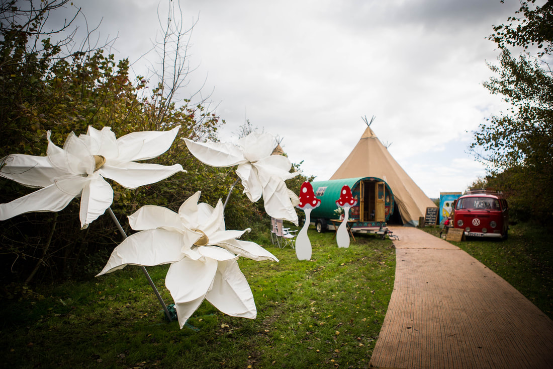 Large white flowers outside of tipis 