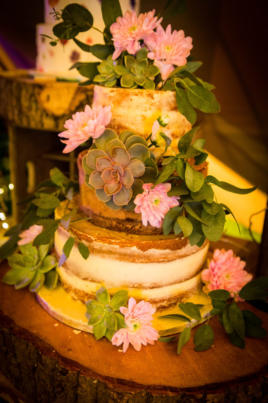 Rustic semi naked wedding cake with fresh flowers