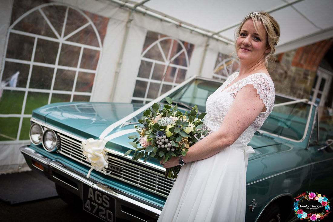Bride in front of wedding car