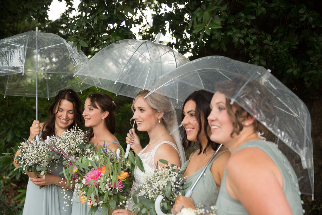Bride & bridesmaids with umbrellas