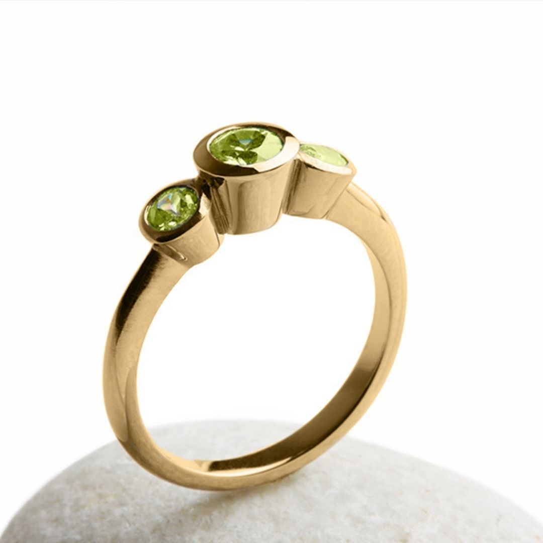 Gold ring with 3 green stones