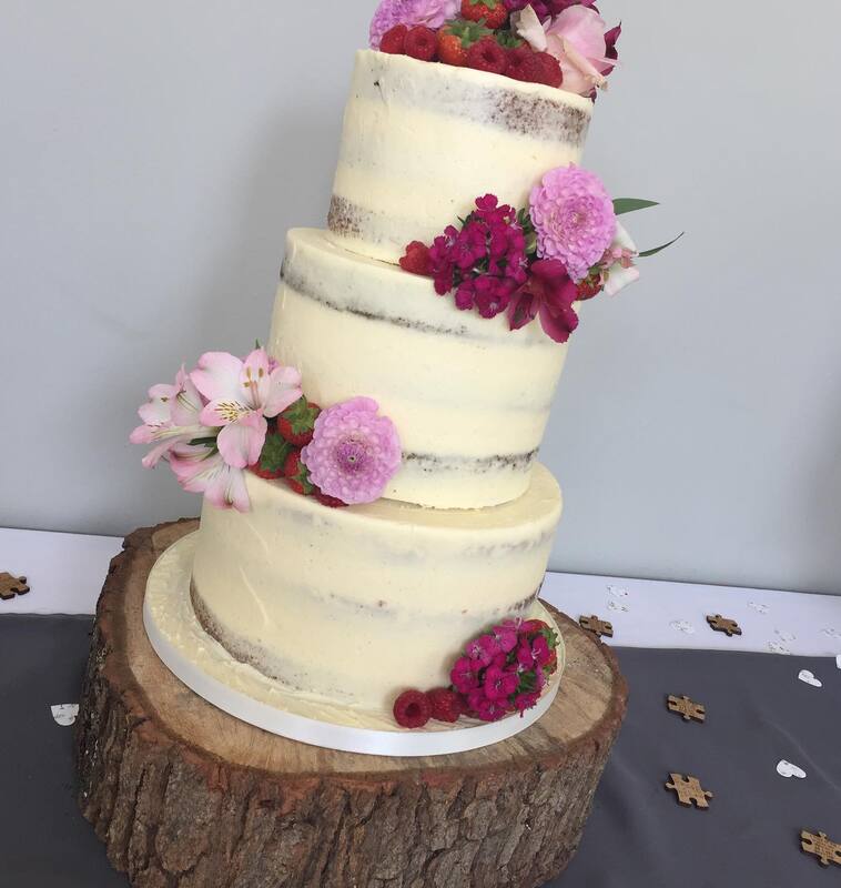 Semi naked wedding cake with pink fresh flowers