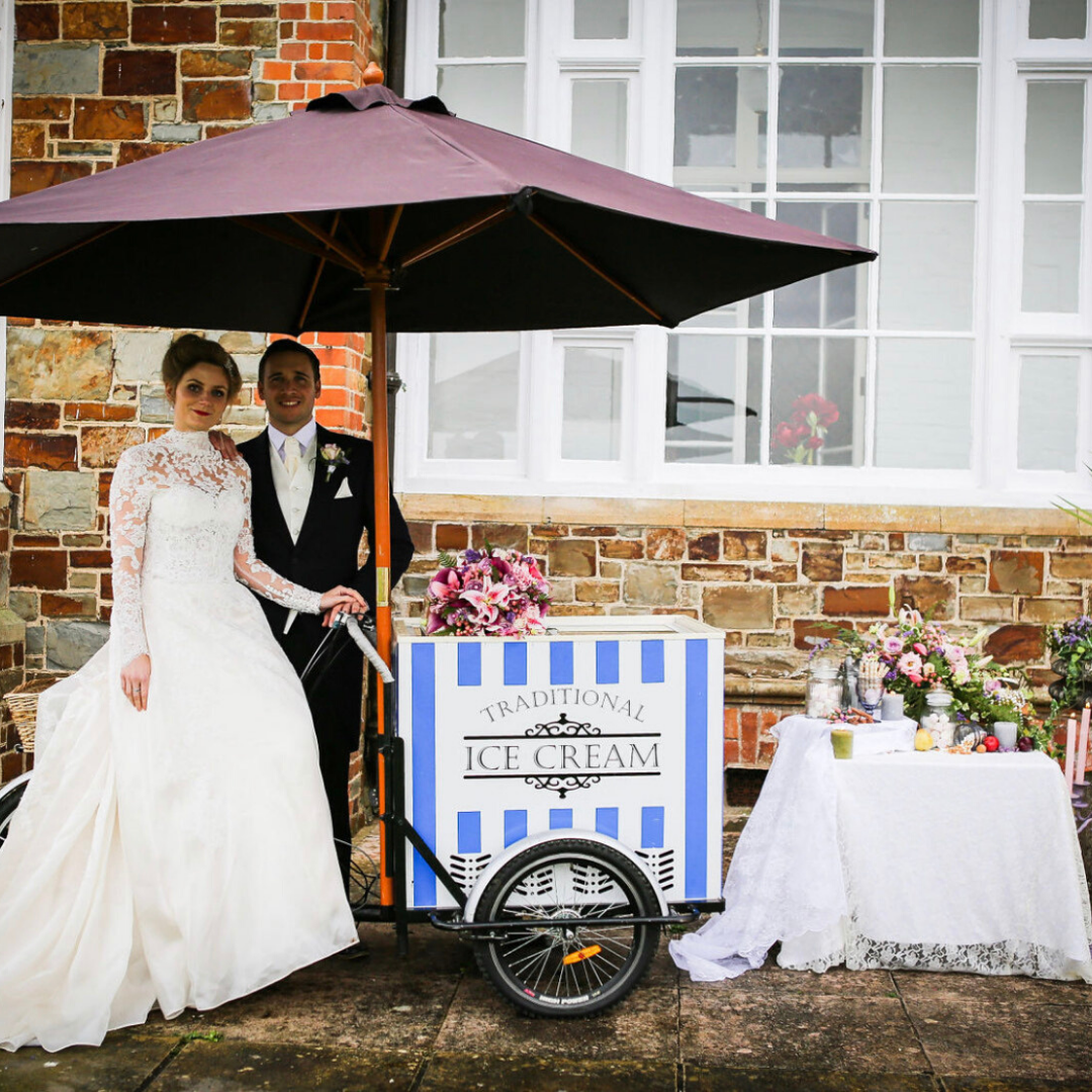 Happy couple next to ice cream tricycle 