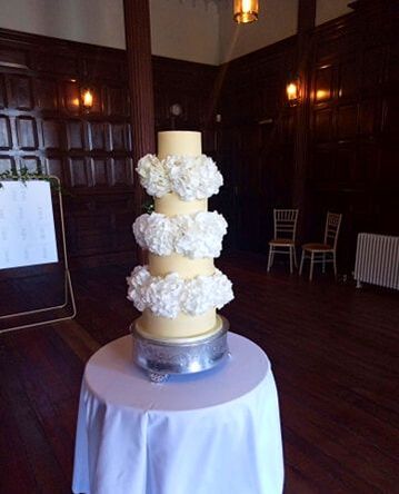 4 tier ganached wedding cake with fresh hydrangea separators