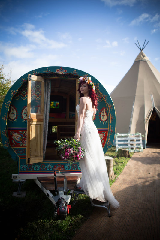 Bride in front of gypsy caravan