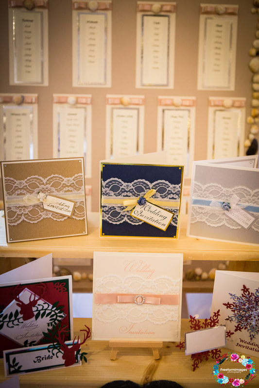 Selection of lace invites by clares wedding creations